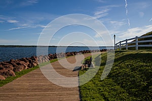 Wooden boardwalk along the waterfront with benches and street lights in Charlottetown, Prince Edward Island, Canada