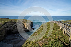 Wooden boardwalk and coast at the Playa de las Catedrales national monument in Galicia photo