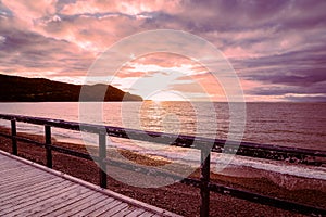 Wooden boardwalk overlooking the Atlantic Ocean during sunset at Placentia Newfoundland Canada photo