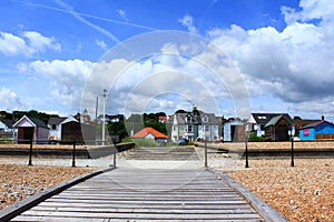 Wooden boardwalk Kingsdown beach huts Kent UK