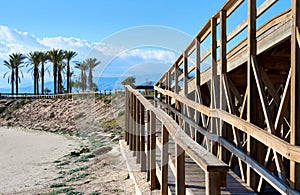 Wooden boardwalk leading to the Retamar beach photo
