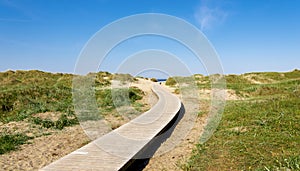 A wooden boardwalk leading to Solastranden beach from the car park and hotel resort