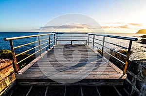 A wooden boardwalk overlooking the ocean