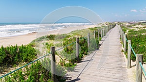 Wooden boardwalk at the Praia da Frente Azul, in english the blue beach front in the seaside resort Espinho photo