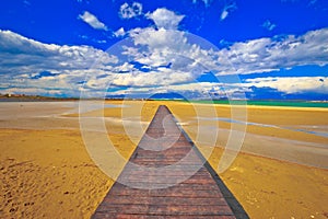 Wooden boardwalk and sand beach of Nin