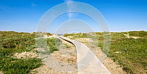 A wooden boardwalk from Sola Strand Hotel to the beach