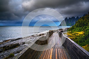 Wooden boardwalk at Tungeneset beach on Senja island in northern Norway photo