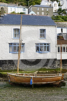 Wooden boat aground and old house, Polperro