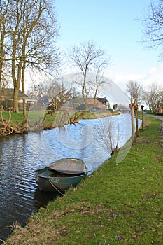 Wooden boat in the canal of Thesinge.Netherlands