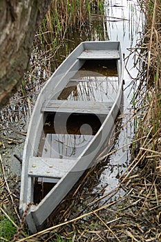 wooden boat in daggers in the water flooded