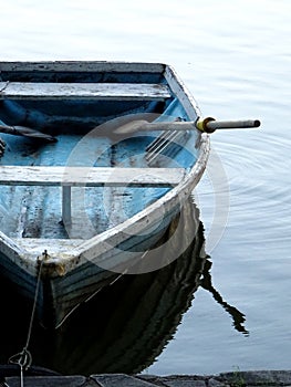 Wooden boat and its reflection