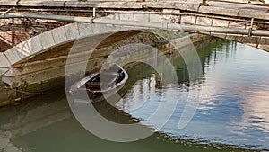 Wooden Boat Moored Under the Bridge