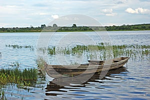 Wooden boat near riverbank