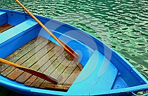 wooden boat with oars on the lake