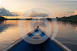 Wooden boat overlooking the sunset or sunrise in the Amazon river