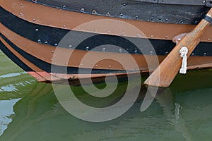 Wooden boat with a paddle closeup
