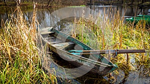 Wooden boat in reeds on river