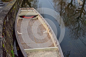 A wooden boat by the river bank