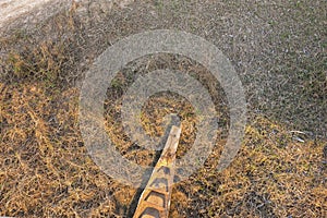 A wooden boat rotting on the dry grass