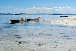 Wooden boat in the shallow water of borneo pulau mataking