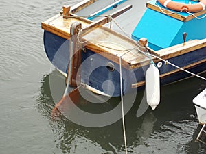 Wooden boat stern and rudder on a mooring