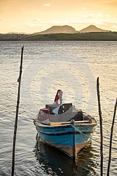 Wooden boat at sunset on Ilhas das Caieiras in the municipality of Vitoria photo