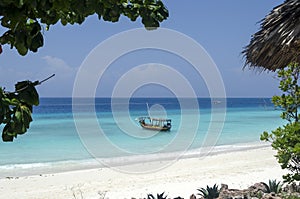 Wooden boat on turquoise water in Zanzibar