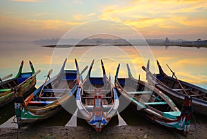 Wooden boat in Ubein Bridge at sunrise, Mandalay, Myanmar