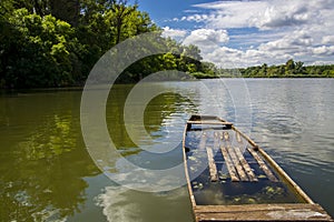 Wooden boat and the view of the backwater of Tisza