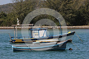 Wooden boats anchored in connection channel with the sea