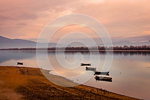 Wooden boats floating on the calm water of Kerkini lake