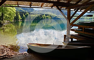 wooden boats by lake Alpsee in Bavarian Alps in Schwangau near castles Hohenschwangau and Neuschwanstein, Bavaria, Germany