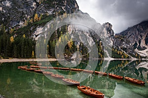 Wooden boats on the peaceful lake. Lago di braies, Italy