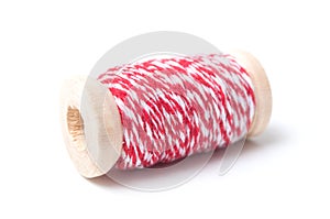 Wooden bobbins of red cotton yarn