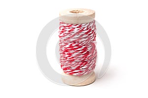 wooden bobbins of red cotton yarn