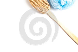 Wooden body brush and sponge for massage and scrub on white background with copy space - skincare in shower and bath