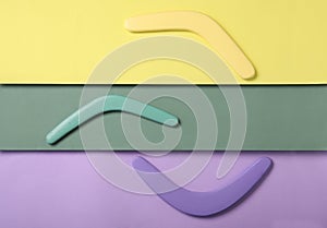 Wooden boomerangs on color background, flat lay
