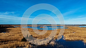 Wooden Bords Trail Through the Kaniera Lake Reeds Aerial Spring Shot Lapmezciems, Latvia