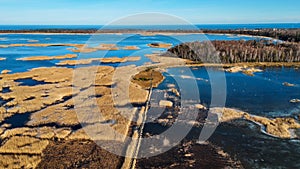 Wooden Bords Trail Through the Kaniera Lake Reeds Aerial Spring Shot Lapmezciems, Latvia.