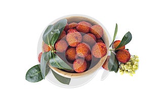 Wooden bowl with arbutus unedo fruits