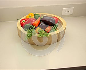 Wooden Bowl Of Artificial Vegetables On Kitchen Counter