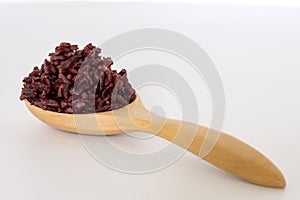 Wooden bowl with brown rice ready to eat. Deep Purple rice,