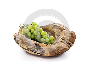 Wooden bowl with a bunch of grapes