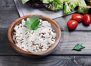 Wooden bowl with cooked white long-grain and wild rice