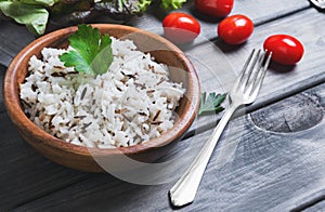 Wooden bowl with cooked white long-grain and wild rice