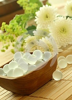 Wooden bowl of decorative balls and flowers