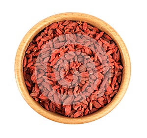Wooden bowl with dried goji berries isolated on white