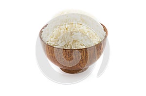 Wooden bowl full of Jasmine rice on white background