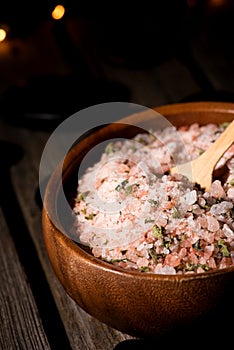 Wooden bowl full of pink sea salt