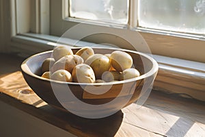 A wooden bowl full of raw potatoes on a sunny windowsill, perfect for home cooking, organic food topics, and farm-to